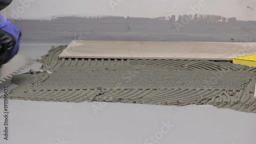 Close Up of Worker Installing Ceramic Floor Tiles