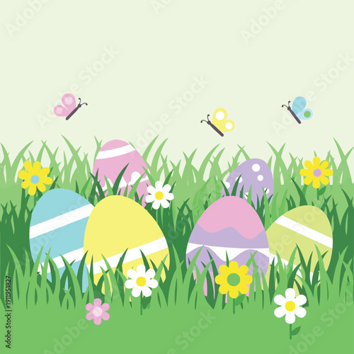 Easter eggs in green grass with spring flowers and butterflies under clear sky