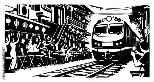 Famous Hanoi train street scene with people sitting at cafes as the locomotive passes in Vietnam