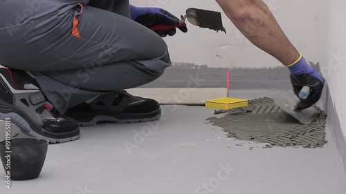 Close Up of Worker Installing Ceramic Floor Tiles