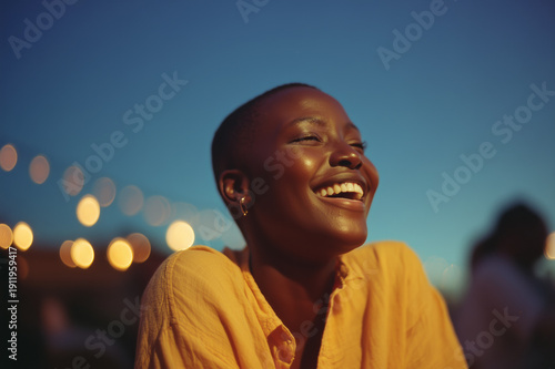Close-up portrait of a black laughing girl outdoors. Sincere emotions, lively atmosphere, bright but natural colors.