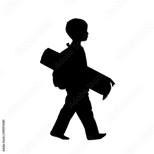 Silhouette of a boy walking with backpack and sleeping bag