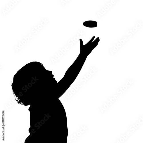 Silhouette of a child throwing a frisbee