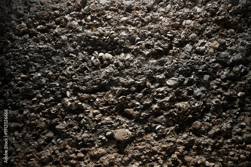Photos Close-up texture of dark gravel and soil mixture on ground surface