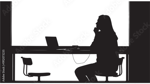 Woman working on laptop and talking on phone in office environment from side view
