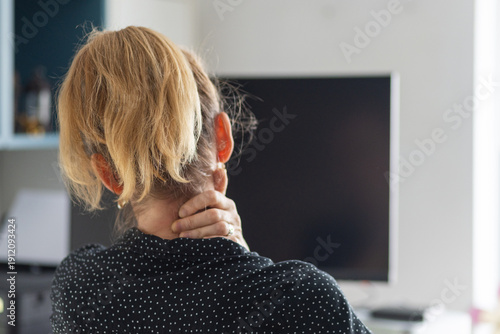Wallpaper Mural woman suffering from neck pain at her desk Torontodigital.ca