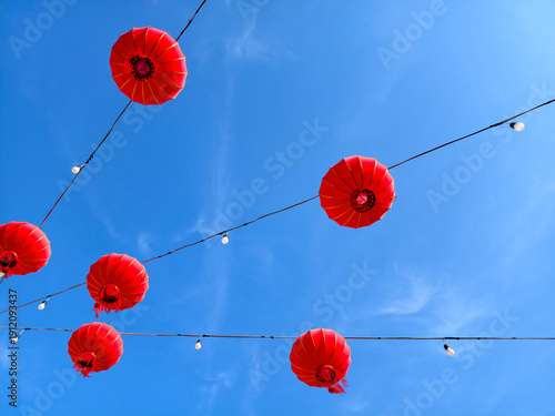 Red Chinese Lanterns Hanging Against Blue Sky for Lunar New Year Festival