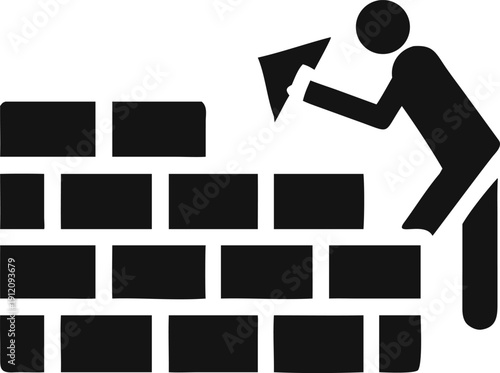 Diligent construction worker meticulously builds a sturdy brick wall with a hand trowel