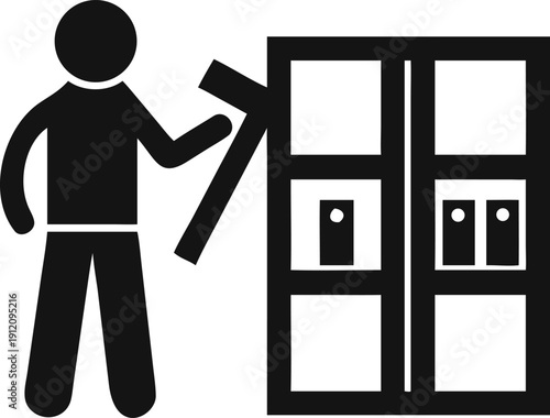 Male worker assembling or repairing a cabinet using a hammer and carpentry tools