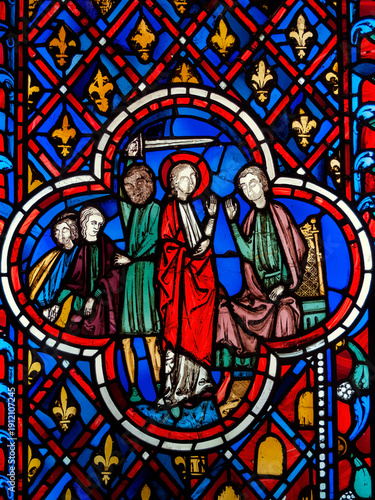 Gothic 13th-century stained glass window panel from Paris's Sainte-Chapelle, depicting intricate biblical narratives, religious stock photo image