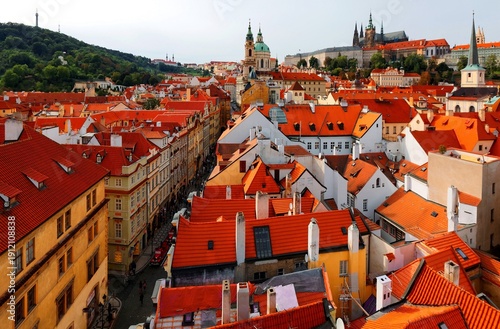 Wallpaper Mural Aerial view of Prague Old Town, capital of Czech Republic & a UNESCO heritage city, with the castle on a hilltop, St. Nicholas Church in Lesser Town & red rooftops of historical houses by a street  Torontodigital.ca