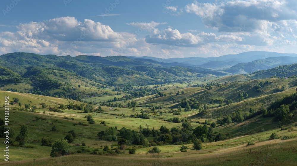 Obraz premium Valley Panorama: The vista opens, a sprawling valley with rolling hills painted in vibrant hues under a sky of scattered clouds, evoking a sense of tranquility and the grandeur of nature.