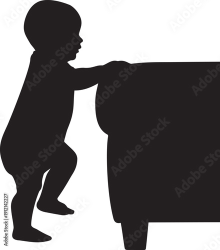 Baby taking first steps silhouette infant standing up by holding sofa furniture while learning to walk during early childhood