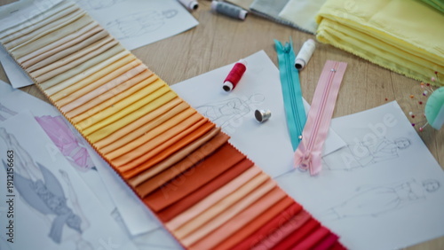 Various sewing tools lying on table atelier workshop closeup. Colorful samples