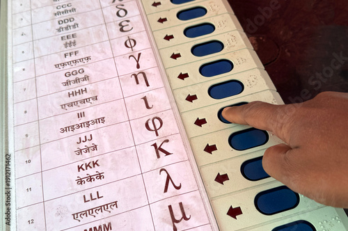 Person presses a button on an Electronic Voting Machine (EVM)