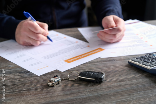 фотографія A close-up of car keys and a beautiful keychain on table.