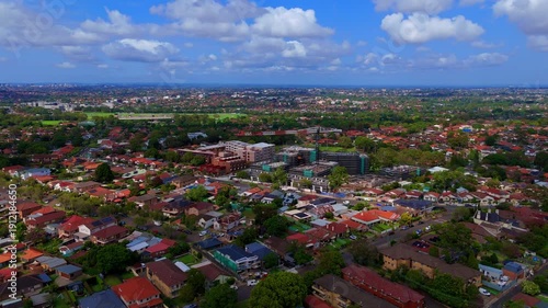 Drone panoramic aerial view of Sydney NSW Australia city Skyline and looking down on roof tops streets roads trees and parks in Suburban Sydney inner west suburbs of Burwood Ashfield Croydon Summer Hi