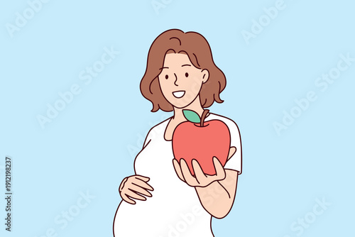 Beautiful pregnant woman holds a fresh apple to her belly, highlighting the importance of organic nutrition and vitamins. She focuses on healthcare and wellness for herself and her baby.