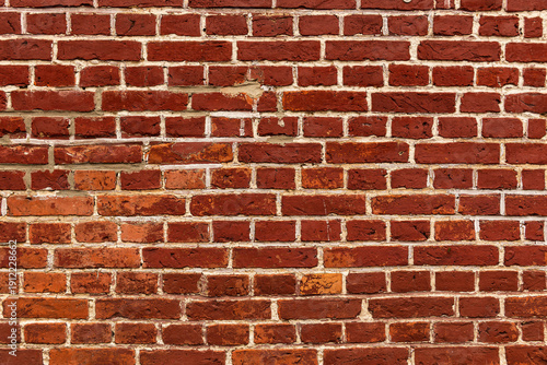 Full frame shot of a weathered old red brick wall with white joints, suitable as a background texture not only for architectural or historic topics