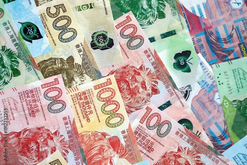 Big pile of Hong Kong dollars money bills banknotes close up. Lots of money of Chinese Hong Kong HKD currency cash in big bunch. Economics and business in HongKong