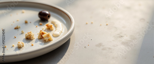 Crumbs and jam stains on a plate after a hasty suhoor meal  