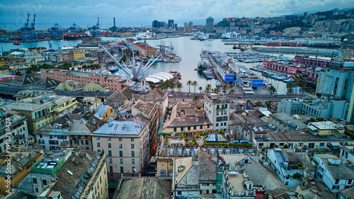 Fotografia Drone view from Genoa's old town looking out over the Porto Antico and industrial harbor in Italy