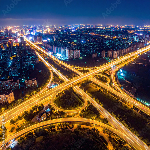 Capture the dynamic energy of urban infrastructure with this highangle night shot of glowing highway light trails. A perfect metaphor for connectivity, logistics, and modern city life.
