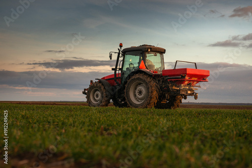 Принти на полотні Tractor spreading artificial fertilizers in field