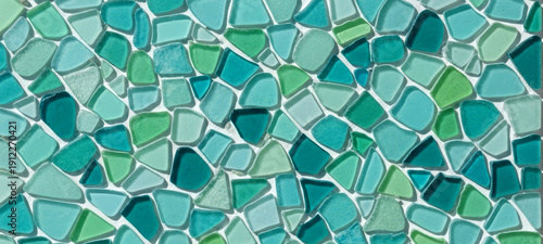 Handcrafted turquoise mosaic composed of sea glass in blue and green tones, creating an organic abstract pattern ideal for eco interior design, texture, and craft projects.
