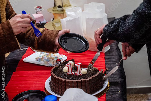 Wallpaper Mural Cutting chocolate birthday cake celebrating 11th anniversary party Torontodigital.ca