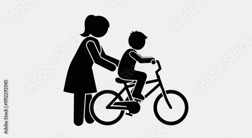 Woman helping a child ride a bicycle.