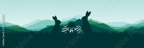 Serene outdoor scene with silhouette of bunnies in fresh green valley