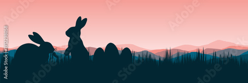 Wide screen spring banner featuring bunnies and easter eggs in meadow