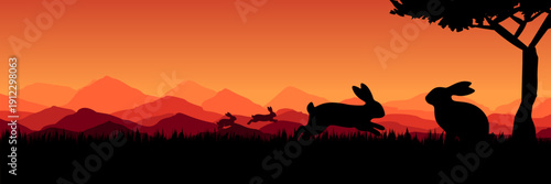 Wide screen spring banner featuring bunnies playing in meadow at sunset