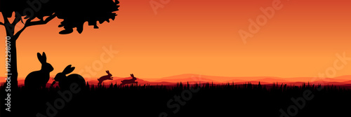 Panoramic Easter background with rabbit silhouettes and orange mountain landscape