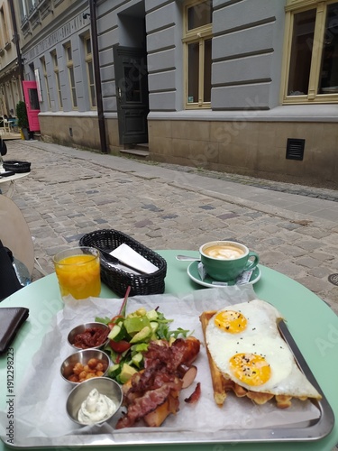 Traditional breakfast plate served outdoors on street cafe table.