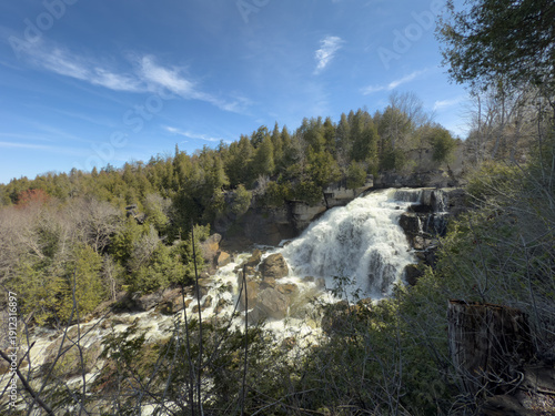 Beautiful waterfall flowing over a rocky escarpement on a sunny day