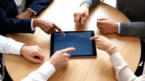 Diverse team collaborating around a tablet displaying financial charts and world map