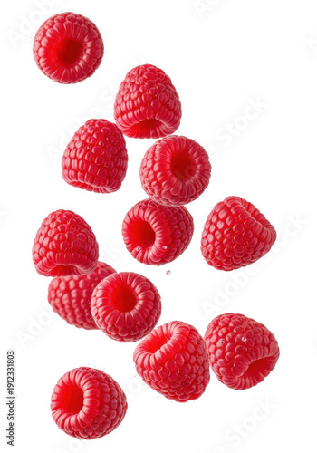 Ripe red raspberries with water droplets falling mid-air against a transparent background in a macro shot. Concept for healthy food advertising