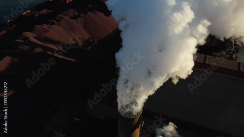 Industrial refinery smokestack emitting toxic smokes net zero emissions by 2050. Harmful industrial emissions pollute air, causing environmental damage, climate change, and sustainability challenges.