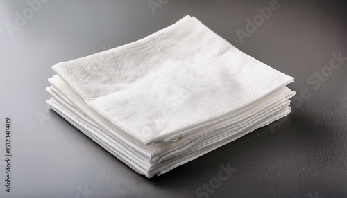 a stack of white square napkins