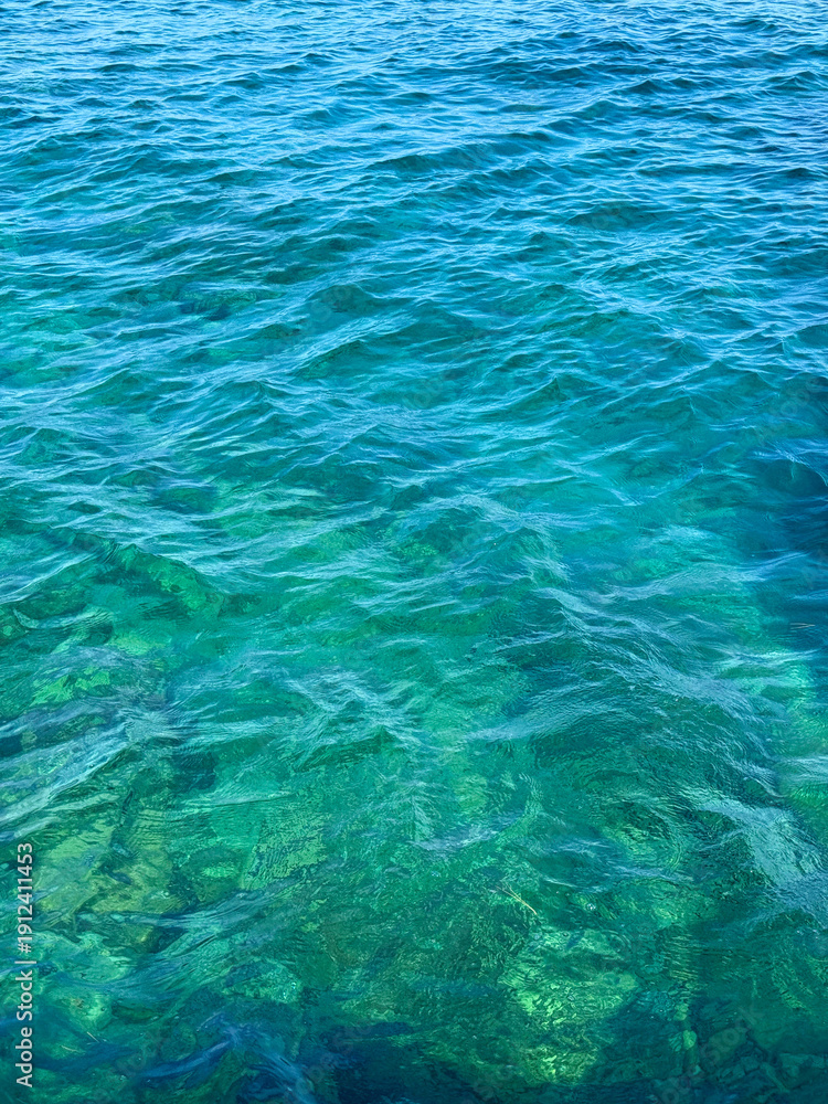 Fototapeta premium Water sea ocean clear blue surface vertical.
