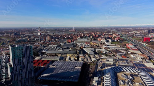 Aerial view of cityscape with solar panels and highway traffic