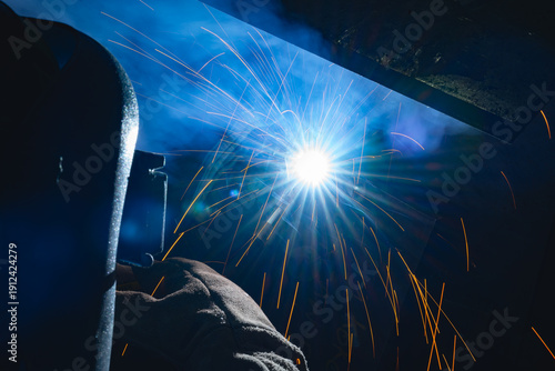 Industrial welder welding fabricated construction in factory, Welding process by Flux Core Welding, FCAW