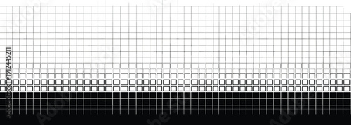 A high-angle view of a grid pattern transitioning from white to black