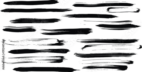 Abstract brush strokes in black and white, creating dynamic, expressive marks on a clean background from a close-up viewpoint.