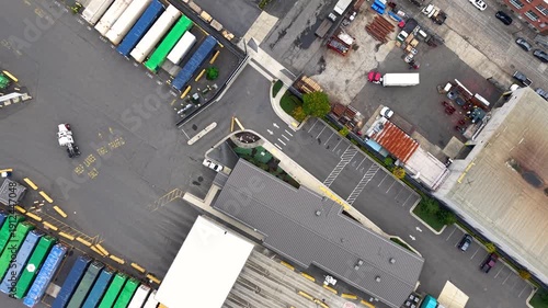 Aerial shot flying forward over a large industrial park with warehouses, distribution centers and rail road in Oregon.