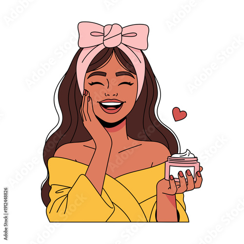 Smiling woman applying face cream with pink headband and yellow robe