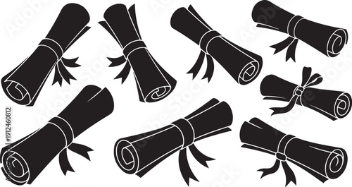 Collection of rolled up black towels with ribbons tied