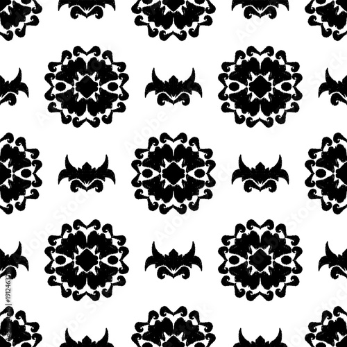 Ikat seamless pattern with decorative flower elements. Black and white background. Seamless abstract background with repeating elements. Design for wallpaper, tiles, and rugs.